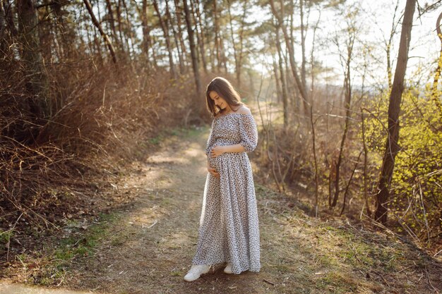 Jeune femme enceinte se détendre dans le parc en plein air