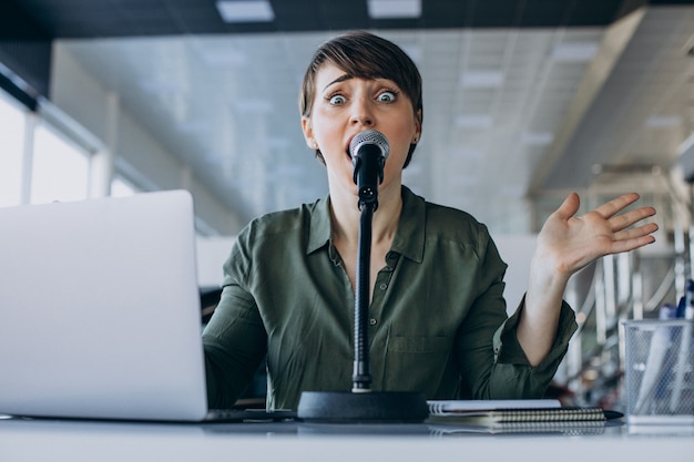 Jeune femme enregistrant un doublage au studio