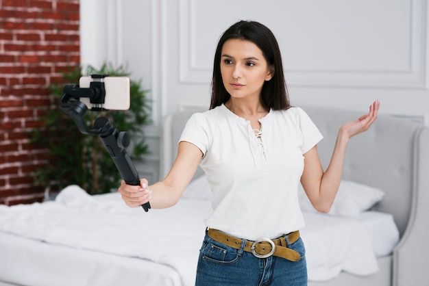 Jeune femme enregistre à la maison