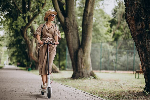 Jeune femme, équitation, scooter, dans parc