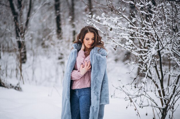Jeune femme marchant dans un parc d&#39;hiver