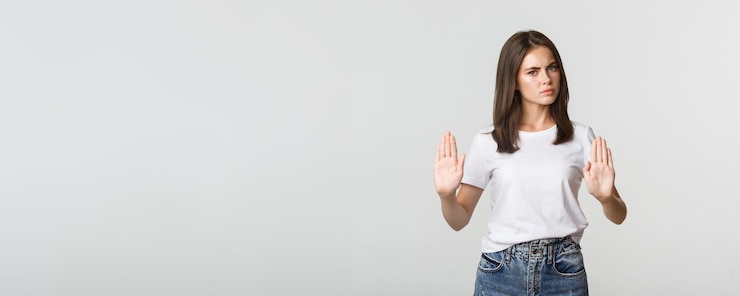 Photo gratuit jeune femme mécontente sérieuse montrant un geste d'arrêt disant non
