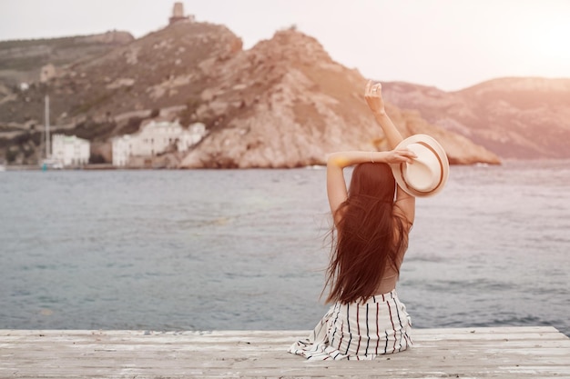 Jeune femme mignonne décontractée près de la mer à l'extérieur