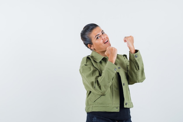 Jeune femme montrant le geste du gagnant en t-shirt