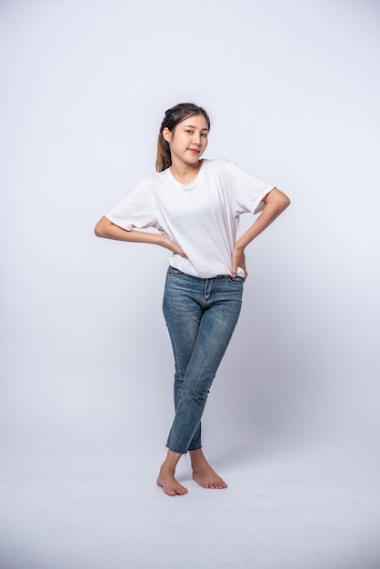 La jeune femme portait une chemise blanche et posa sa main sur sa taille.