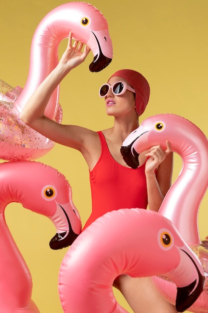 Jeune femme posant avec anneau de natation flamingo