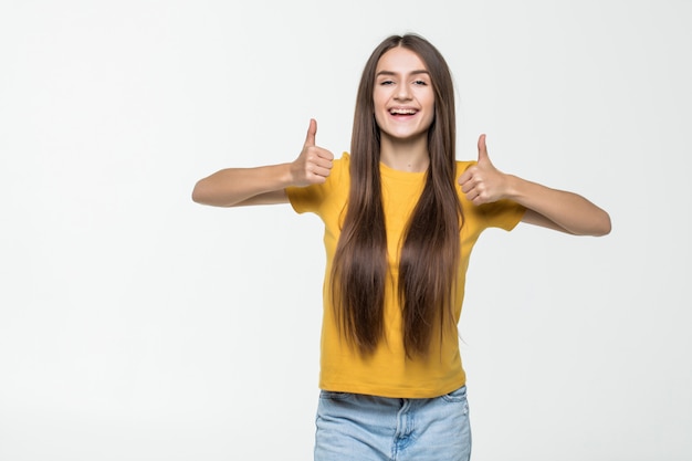 Jeune Femme, à, Pouces Haut, Isolé, Sur, A, Mur Blanc