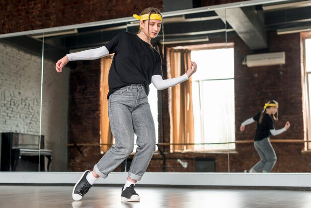 Jeune femme pratiquant la danse devant un miroir