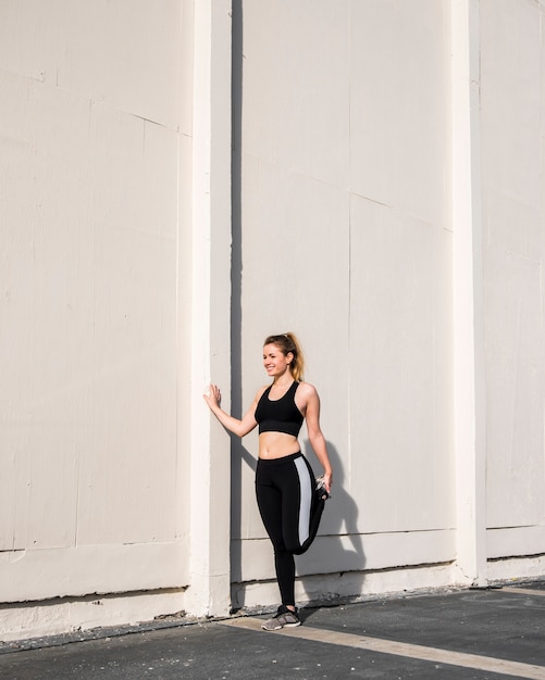 Photo gratuite jeune femme qui s'étend dans la rue