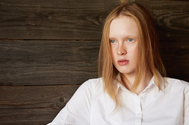 Jeune femme rousse au café