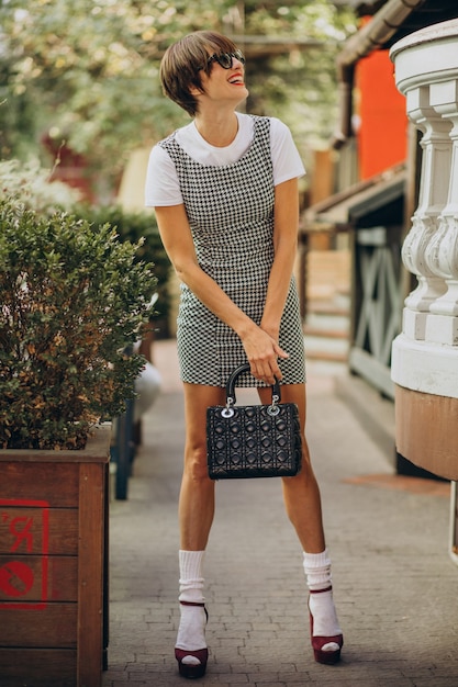 Jeune femme avec sac à l'extérieur de la rue