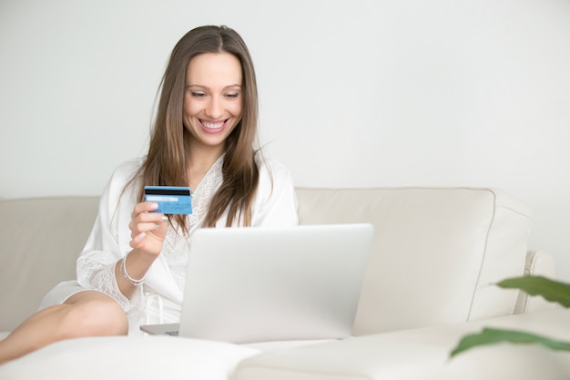 Jeune femme souriante payant avec une carte