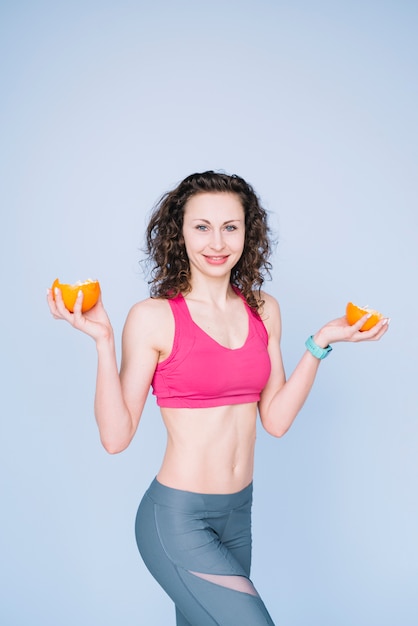 Photo gratuite jeune femme tenant une orange