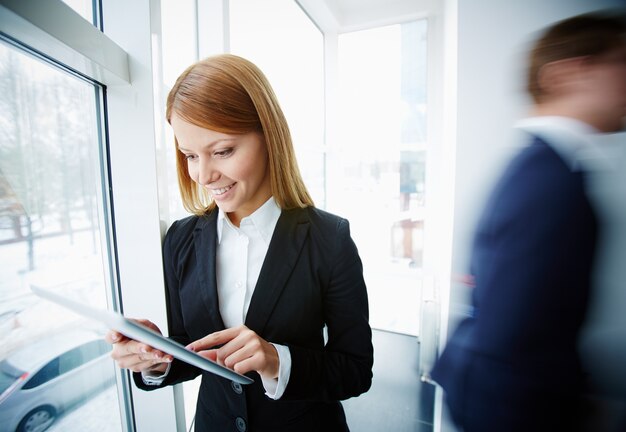 Jeune femme travaillant près de la fenêtre