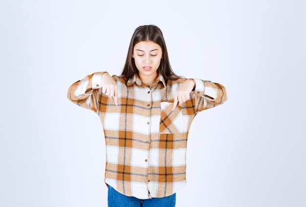 jeune fille debout et pointant vers le bas avec l'index.