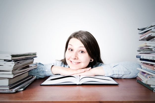 Une jeune fille mignonne intelligente qui étudie.