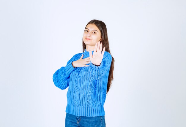 jeune fille pointant vers l'avant pour s'arrêter sur blanc.