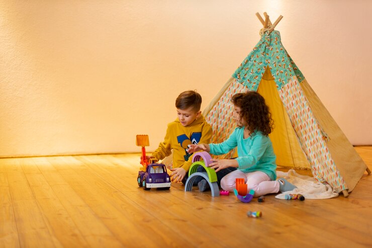 Photo gratuit jeune garçon et fille jouant à l'intérieur avec des jouets écologiques