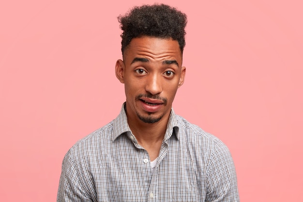 Jeune homme aux cheveux bouclés et chemise avec motif