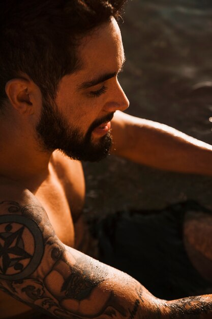 Jeune homme barbu avec tatouage