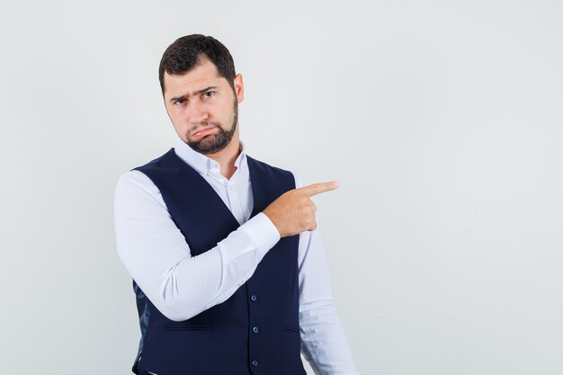 Jeune homme en chemise, gilet pointant vers l'extérieur pour se plaindre et à l'offensé