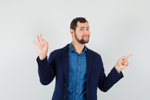 Jeune homme en chemise, veste montrant le geste ok