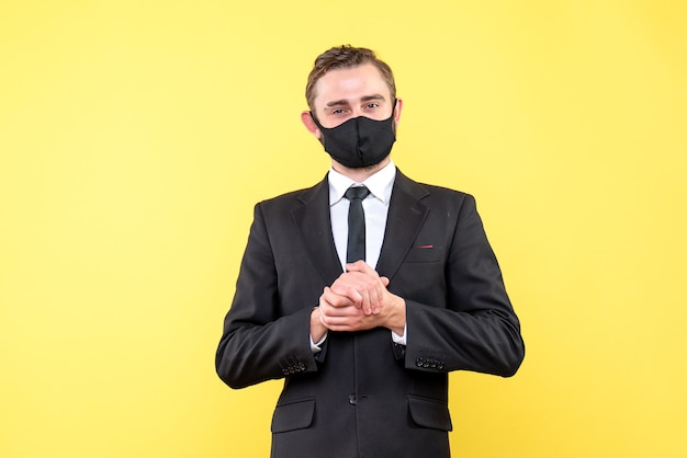 Jeune homme en costume à la recherche d'une expression faciale satisfaite