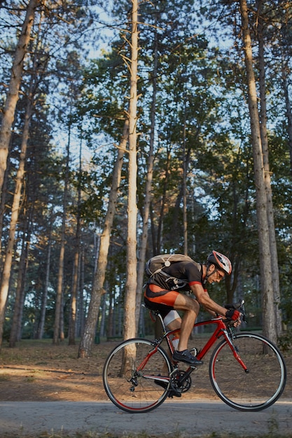 Jeune homme fait du vélo de route le soir