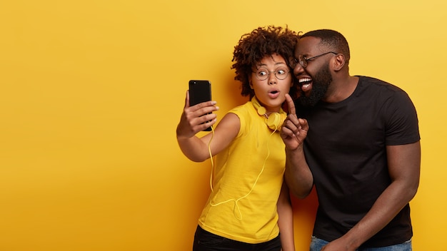 Jeune homme, et, femme tenant téléphone