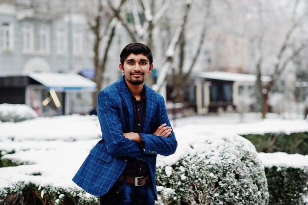 Jeune homme indien en costume posé en plein air en journée d'hiver