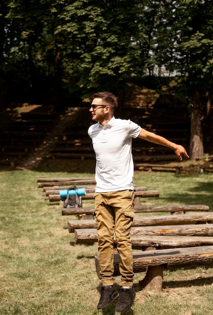 Jeune homme sautant par-dessus des bancs en bois