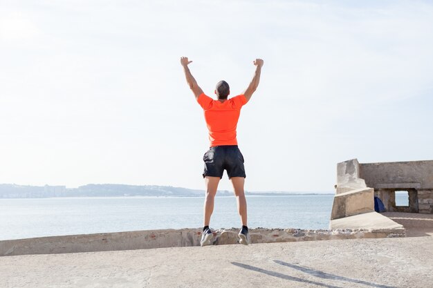 Jeune homme sportif saute en plein air en été