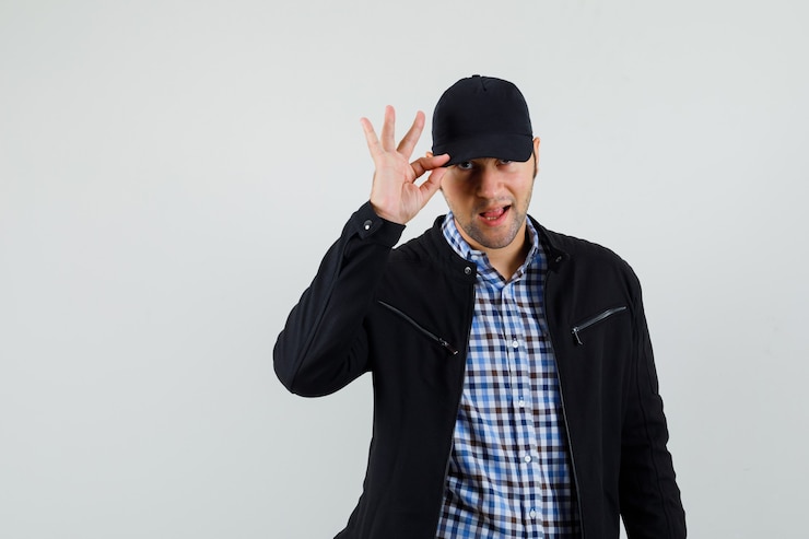 Photo gratuit jeune homme tenant sa casquette en chemise, veste et à la confiance