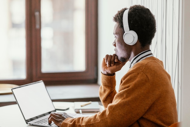 Photo gratuite jeune homme travaillant à domicile