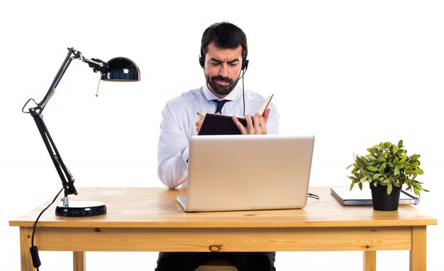 Jeune homme travaillant avec un livre de lecture de casque