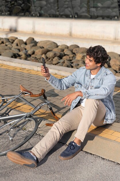 Jeune homme avec un vélo à l'extérieur