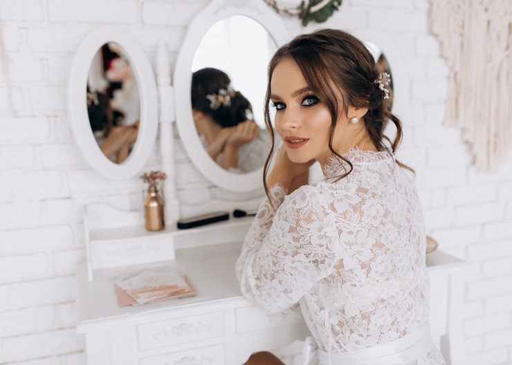 Photo gratuit la jeune mariée regarde joyeusement et mystérieusement devant la caméra