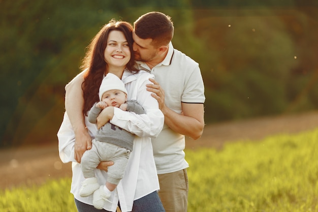 Jolie famille jouant dans un champ d'été