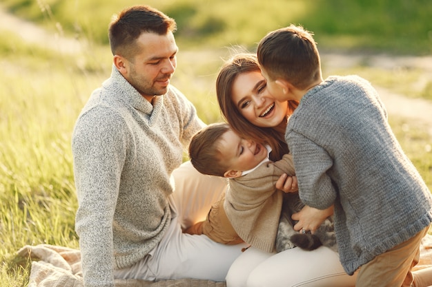 Jolie famille jouant dans un champ d'été