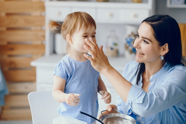 Jolie famille prépare le petit déjeuner dans une cuisine