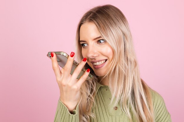 Jolie femme européenne en pull décontracté sur mur rose