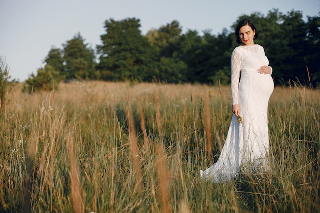 Jolie femme passe du temps dans un champ d'été