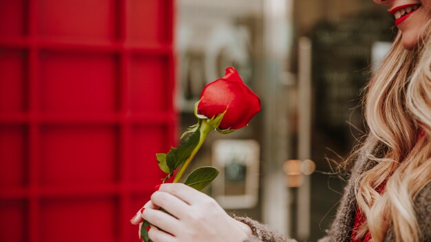 Jolie femme avec une rose rouge