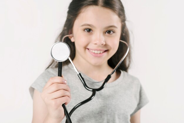 Jolie fille avec stéthoscope en studio