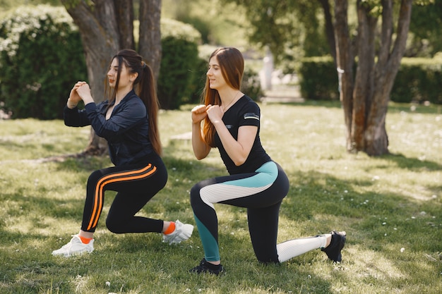 Jolies Filles Faisant Du Yoga Dans Un Parc D'été