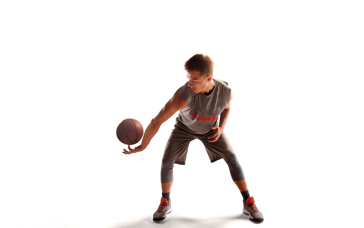 Photo gratuit un joueur de basket-ball en action au coucher du soleil