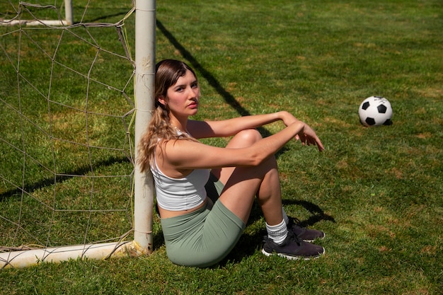 Photo gratuite joueur de football femme plein coup sur le terrain