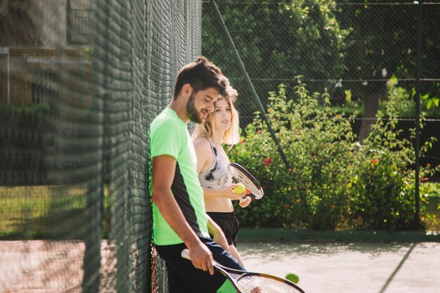 Les joueurs de tennis s&#39;appuient sur une clôture