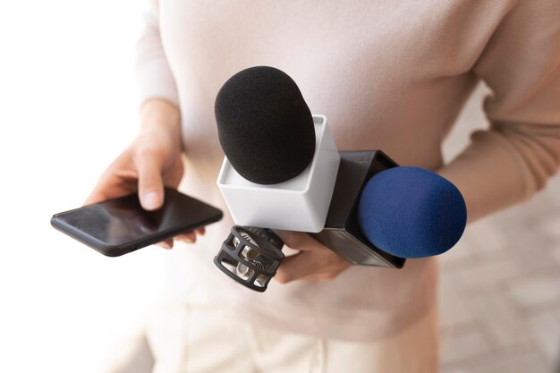 Journaliste vue de face tenant un microphone