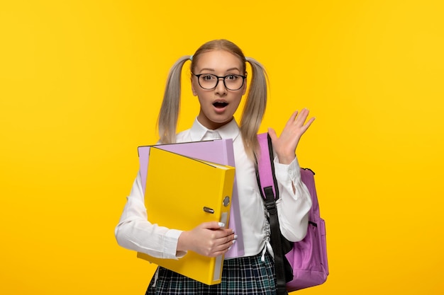 Journée mondiale du livre excitée écolière blonde avec des mains agitées portant des lunettes